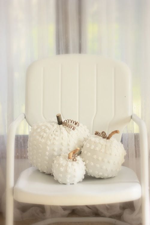 White Chenille Pumpkins on a white chair.
