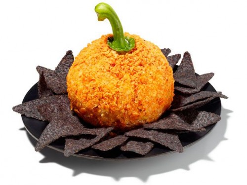 A plate of blue corn tortilla chips with a pumpkin cheese ball in the center.
