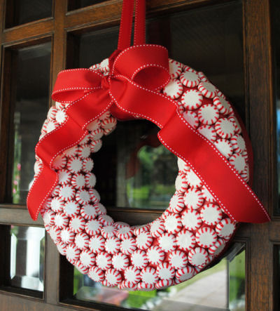 A peppermint candy wreath with a red bow.
