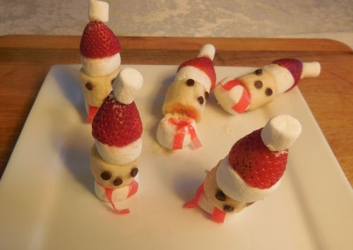 Two Santa treats standing upright and three that have fallen over.