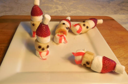 Two Santa treats standing upright and three that have fallen over.