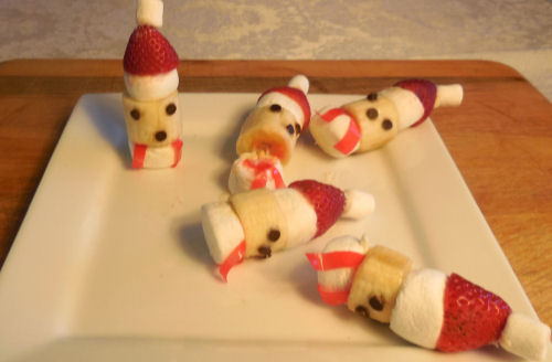One Santa treats standing upright and four that have fallen over.