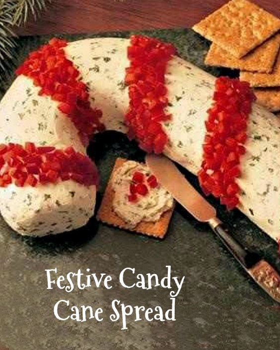 Candy cane shaped cream cheese spread. A festive candy cane spread formed in the shape of a candy cane on a table next to crackers.