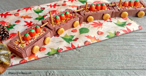 DIY cookie train Thanksgiving DIY cookie train made from candy and wafer cookies, on a wooden table with a fall tablecloth.