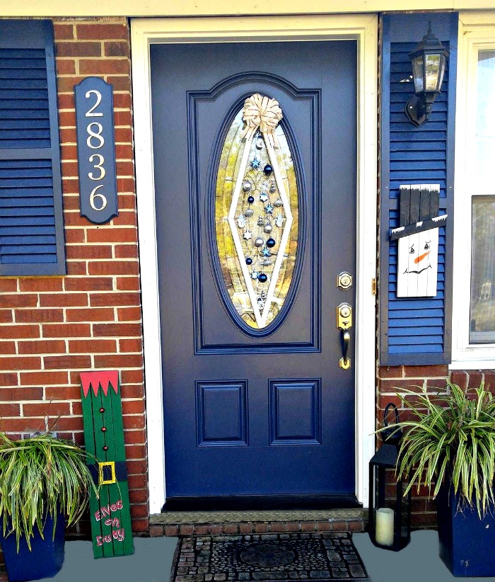 This Christmas ornament door hanger is perfect for front doors that have an oval glass panel in them. This type of door makes a round wreath look odd.