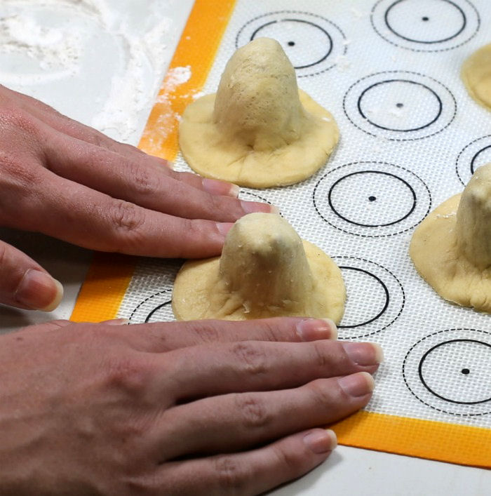 Fingers forming pilgrim hat shapes woman's hands forming pilgrim hats.