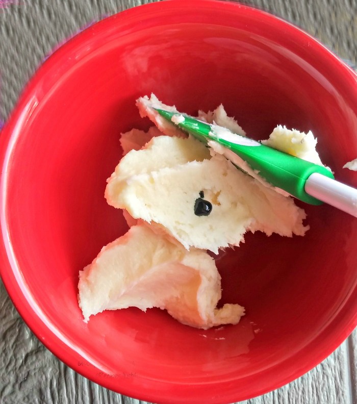 Color the frosting with green gel food coloring