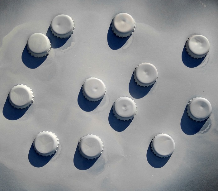 spray bottle caps white Paint the bottle caps whit.