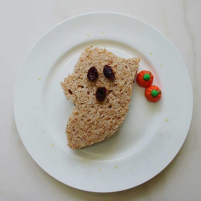Peanut butter and jelly sandwich in the shape of a ghost.