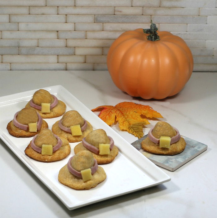 Pilgrim hat appetizers on a plate Pumpkin and leaves with 7 appetizers shaped like Pilgrim Hats