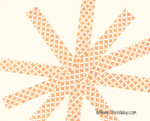 A stack of paper strips attached with a brad in the center and fanned out equally.