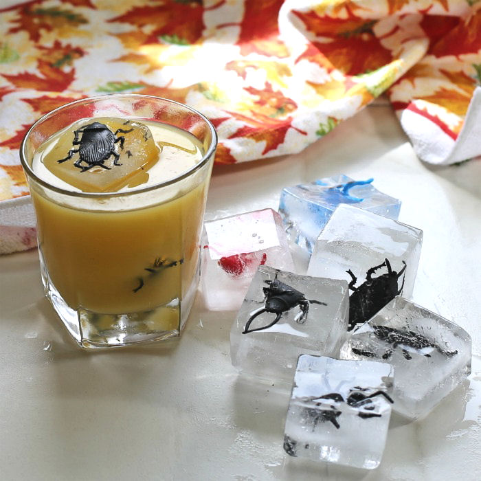 orange juice drink with spider ice cube garnishes Spider ice cube drink