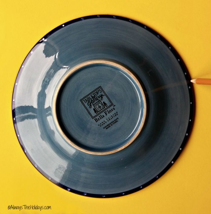 Blue plate on yellow poster board.