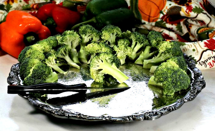broccoli florets on a silver tray with sweet peppers Broccoli on a silver platter