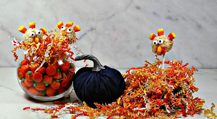 Thanksgiving Rice Krispies treats Rice Krispie turkey pops in a Thanksgiving display with shredded paper and candy pumpkins.