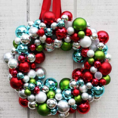 DIY ornament wreath made of green, red, blue, white, silver and pink balls.