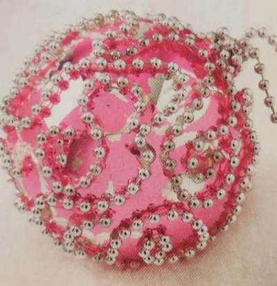 Swirled beaded chain glued onto a chipped ornament to hides chipped paint on this ornament rescue.