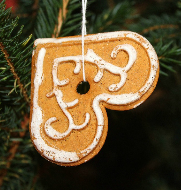 Gingerbread cookie ornament. A gingerbread cookie ornament shaped like a heart, hanging on a tree.