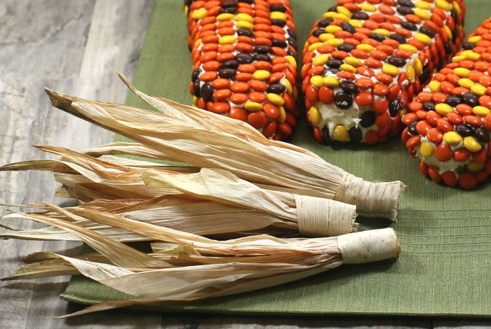 Wrapped corn husks. Corn husks wrapped next to cake slices with Reese's pieces.