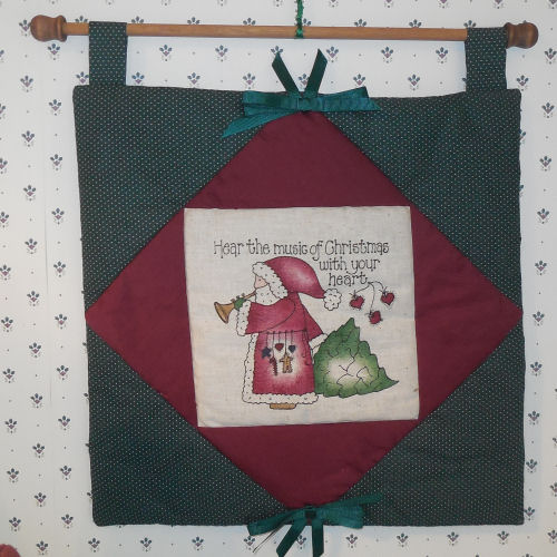 Santa Claus wall hanging. Santa wall hanging that says "Hear the music of Christmas with your heart".