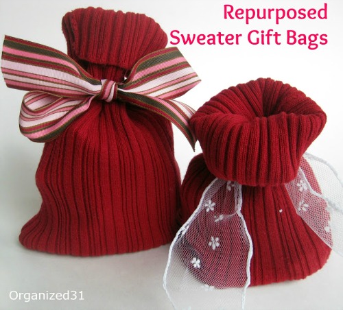 Two red, repurposed sweater gift bags with different wire bows on them.