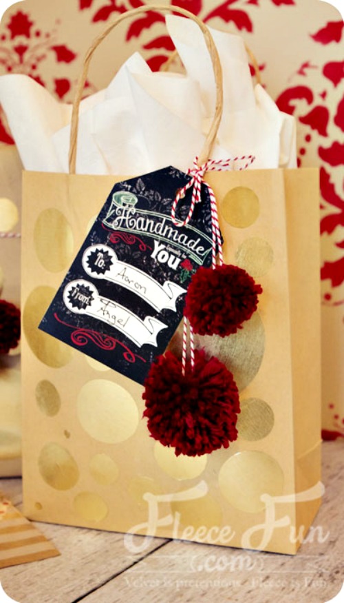 Free Printable gift tags on a golden gift bag with white tissue paper.