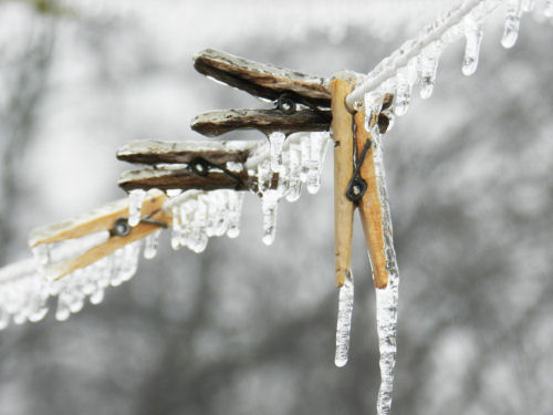 Frozen clothespins. Frozen clothespins clipped to a laundry line.
