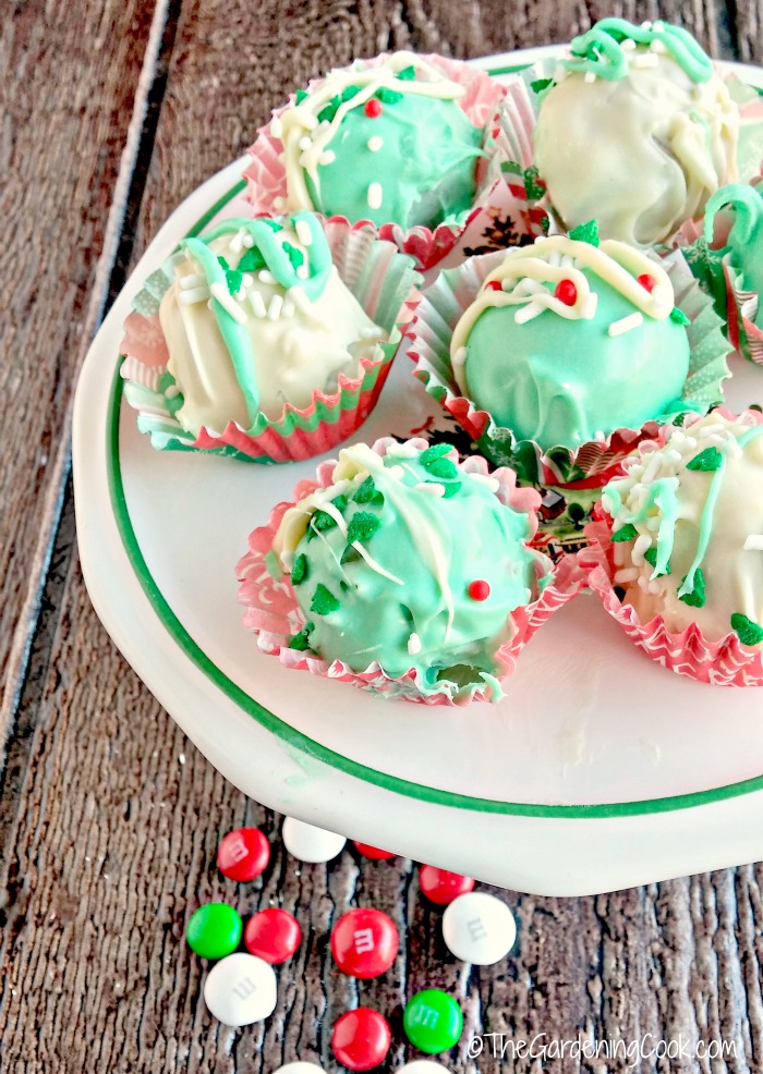Funfetti Christmas truffles. Funfetti peppermint Christmas truffles on a plate with loose m&ms in the foreground.