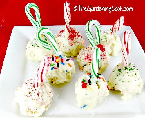 Peppermint stick Rice Krispie ball cookies. A plate of peppermint rice krispie ball cookies with candy canes sticking out of them.