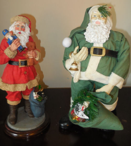 Two porcelain Santa Claus figures. Two porcelain Santa Claus figures, one wearing green and one wearing red.