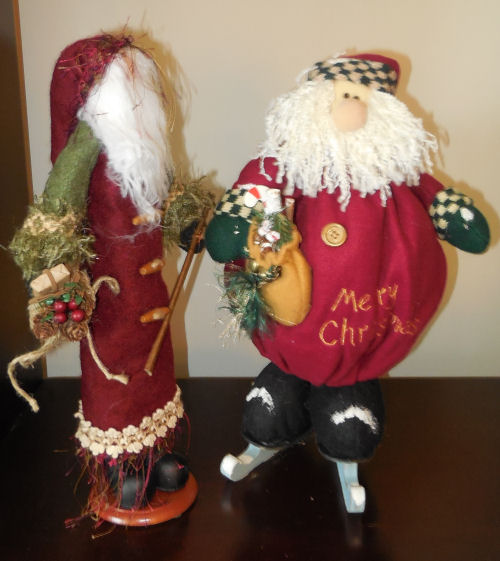 Two Santa Claus figures. Two Santa Claus figures from my husband on a wooden table.