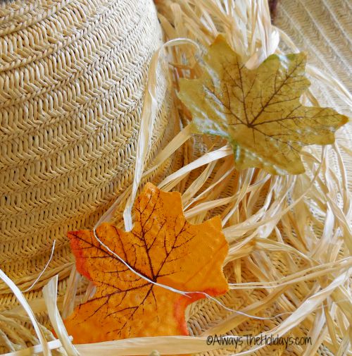 Silk leaves and natural raffia attached to a straw hat with hot glue.