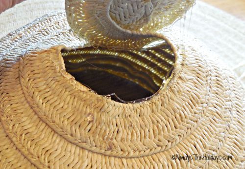 old straw hat A broken straw hat with part of the straw peeled off, that now has a line of hot glue on it so it can be put back together.