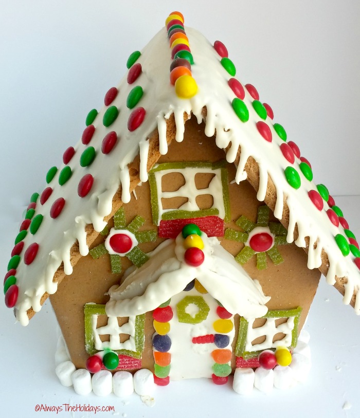 Gingerbread house with candy decorations marshmallows make a picket fence