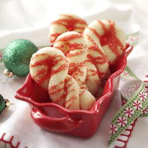 Candy cane cookies. Candy cane cookies in a red serving dish on a white cloth.