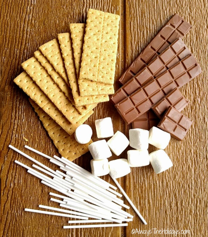 Indoor s'mores ingredients Ingredients for Indoor S'mores including Graham crackers, milk chocolate, marshmallows and cake pop sticks.