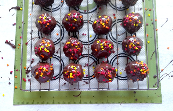 Chocolate peanut butter truffles on a baking rack