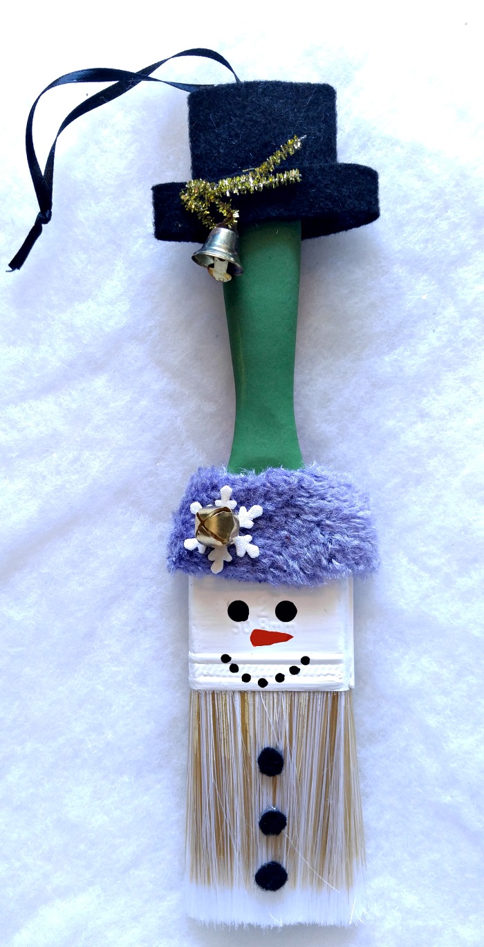 This adorable Snowman Paintbrush Ornament is sure to become a family favorite. It is easy to make and can be hung on a tree or used as a wall hanging.