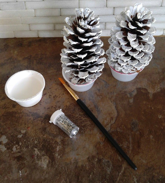 Paint the pine cones and add glitter