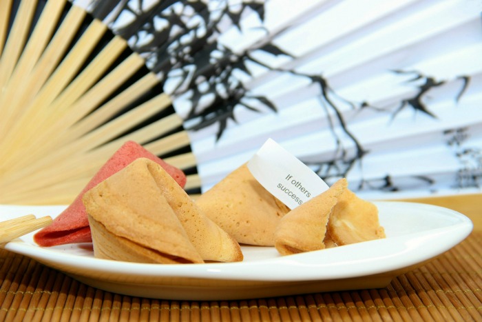 fortune cookies on a plate and a fan fortune cookies