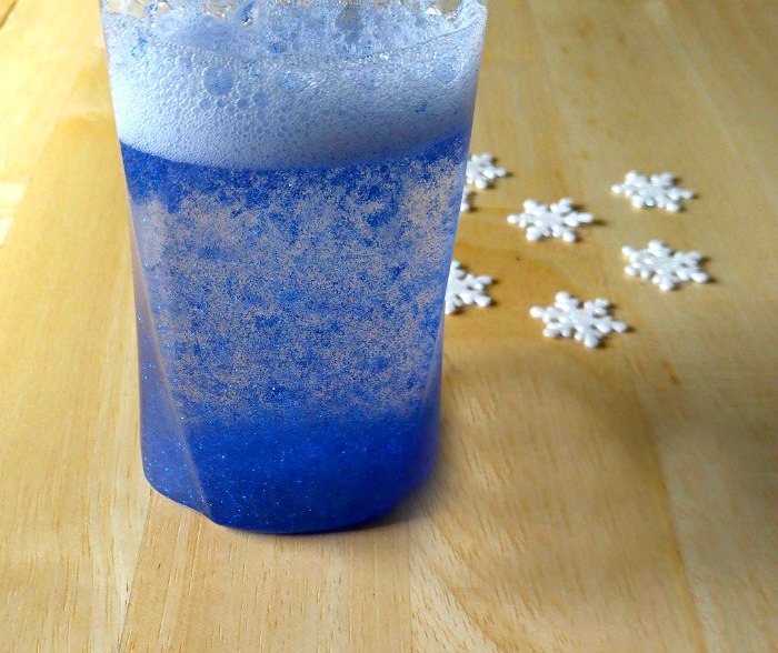Shaken bottle mixed with glitter glue and some white snowflakes.