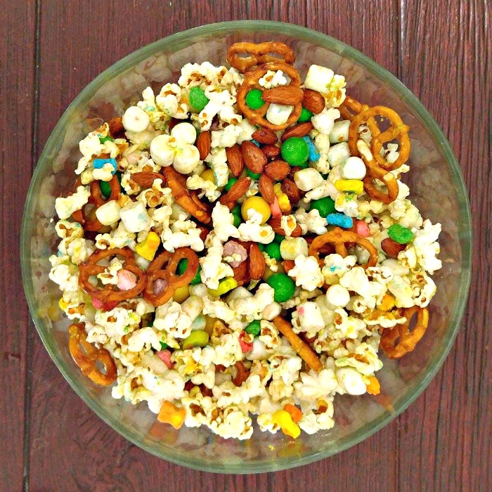 Bowl of Lucky Charms snack mix with popcorn, pretzels, marshmallows and candy.