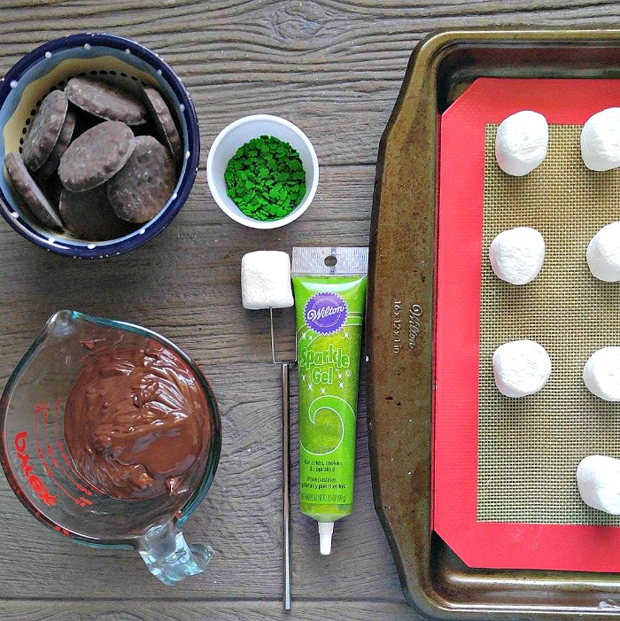 Dipping station for the Leprechaun hats Girl Scout cookies, melted chocolate, green sprinkles, marshmallows and green gel frosting.