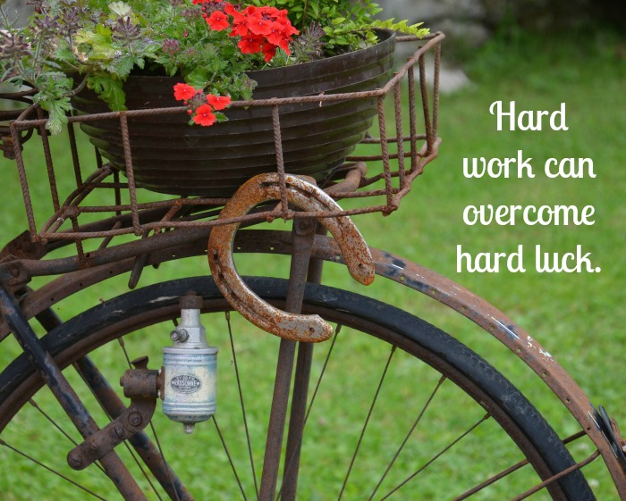 Bicycle with a St. Patrick's Day text overlay. An old bicycle with flowers in the basket with a St Patrick's Day sayings text overlay.