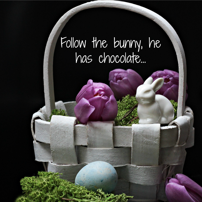 Funny Easter quote over a grey basket with purple tulips, moss and a white porcelain bunny in it.