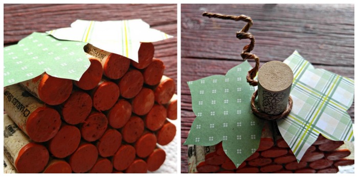 A close up photo of the leaves and stem of a pumpkin wine cork craft.