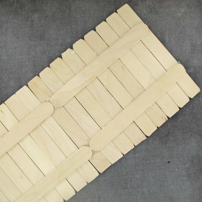 Making the base with craft sticks base of the fence