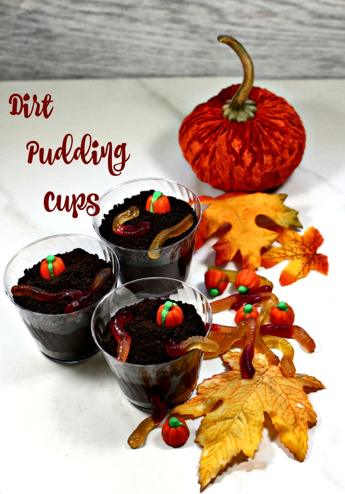 dirt pudding cups pudding with pumpkin and leaves and text reading "dirt pudding cups."