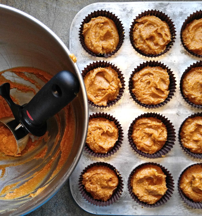 Pumpkin cheesecake muffin batter in muffin cups pumpkin muffin batter
