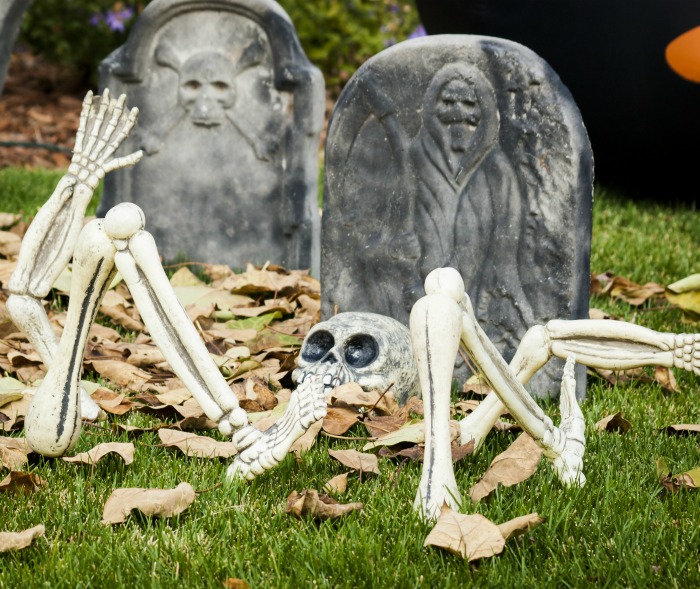 Skeleton and gravestones with leaves
